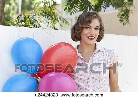 Woman carrying bunch of balloons View Large Photo Image Stock Image - Woman carrying bunch of balloons. Fotosearch