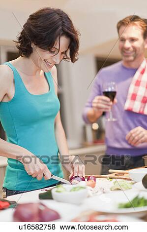 Woman cooking dinner in kitchen View Large Photo Image Stock Photo - Woman cooking dinner in kitchen. Fotosearch