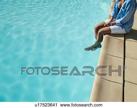 Woman dangling her feet in pool View Large Photo Image Stock Image - Woman dangling her feet in pool. Fotosearch