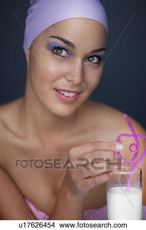 Woman drinking with curly straw View Large Photo Image Picture - Woman drinking with curly straw. Fotosearch