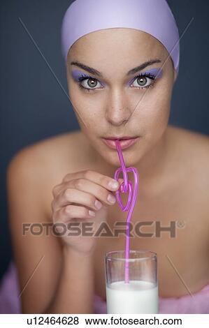 Woman drinking with curly straw View Large Photo Image Stock Photo - Woman drinking with curly straw. Fotosearch