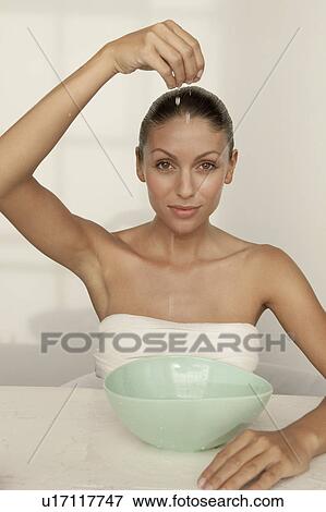 Stock Photo - Woman dripping water into bowl. Fotosearch