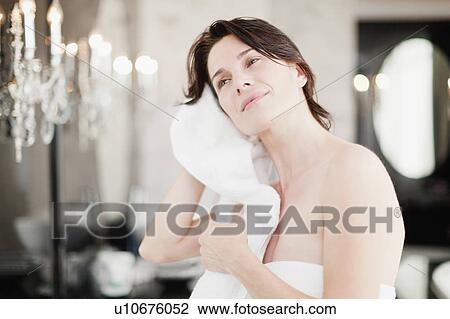 Woman drying her hair in bedroom View Large Photo Image Stock Image - Woman drying her hair in bedroom. Fotosearch