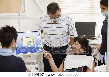 Woman examining model with dentist View Large Photo Image Stock Image - Woman examining model with dentist. Fotosearch