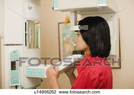 Stock Image - Woman having dental x-rays taken. Fotosearch