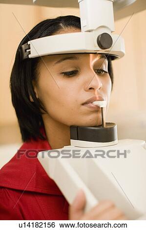 Stock Photograph - Woman having dental x-rays taken. Fotosearch