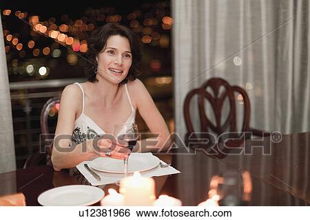 Woman having romantic dinner at home View Large Photo Image Stock Photograph - Woman having romantic dinner at home. Fotosearch