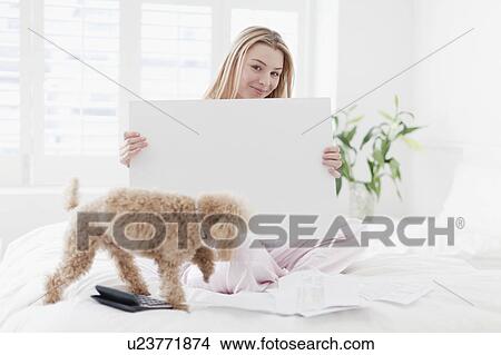 Woman holding blank card with dog View Large Photo Image Picture - Woman holding blank card with dog. Fotosearch