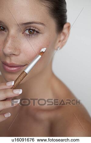 Woman holding brush with makeup View Large Photo Image Stock Photograph - Woman holding brush with makeup. Fotosearch