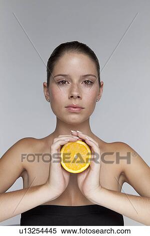 Woman holding halved orange View Large Photo Image Stock Photography - Woman holding halved orange. Fotosearch