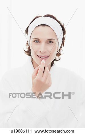 Woman in bathrobe applying makeup View Large Photo Image Stock Image - Woman in bathrobe applying makeup. Fotosearch
