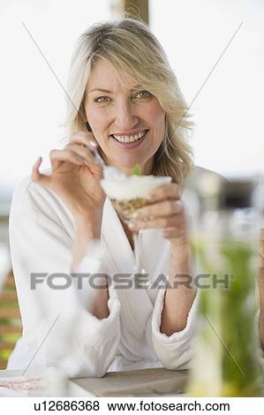 Woman in bathrobe eating breakfast View Large Photo Image Stock Photo - Woman in bathrobe eating breakfast. Fotosearch