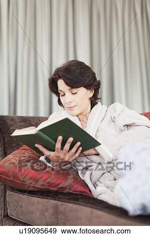Woman in bathrobe reading book View Large Photo Image Stock Photo - Woman in bathrobe reading book. Fotosearch