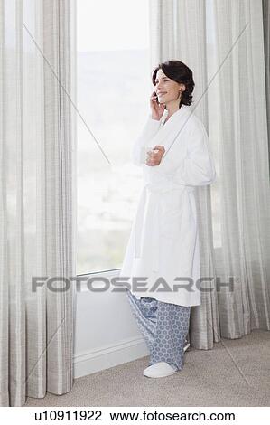 Woman in bathrobe talking on cell phone View Large Photo Image Stock Image - Woman in bathrobe talking on cell phone. Fotosearch