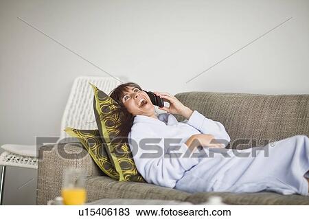 Woman in bathrobe talking on phone View Large Photo Image Stock Image - Woman in bathrobe talking on phone. Fotosearch