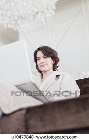 Woman in bathrobe using laptop View Large Photo Image Stock Photo - Woman in bathrobe using laptop. Fotosearch