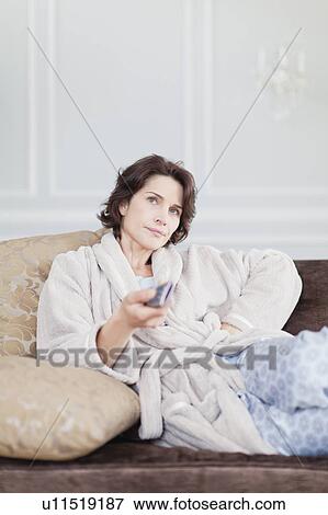 Woman in bathrobe watching television View Large Photo Image Stock Photo - Woman in bathrobe watching television. Fotosearch