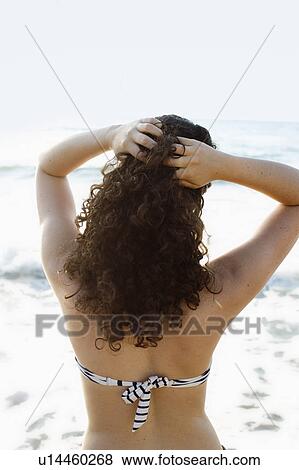 Woman in bikini standing on beach View Large Photo Image Stock Photo - Woman in bikini standing on beach. Fotosearch