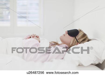Woman in eyemask asleep in bed View Large Photo Image Stock Photograph - Woman in eyemask asleep in bed. Fotosearch