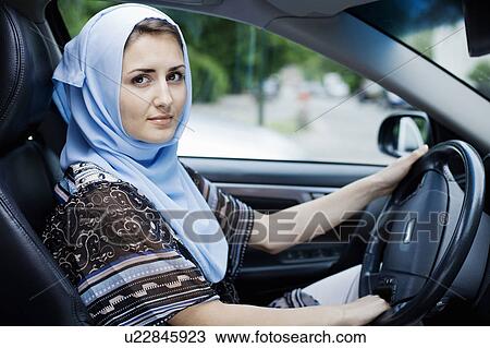 Woman in headscarf driving View Large Photo Image Stock Image - Woman in headscarf driving. Fotosearch