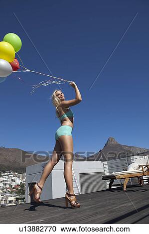 Woman in swimsuit with bunch of balloons View Large Photo Image Stock Image - Woman in swimsuit with bunch of balloons. Fotosearch