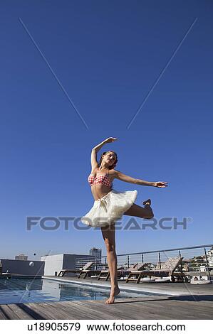 Woman in tutu dancing by pool View Large Photo Image Stock Photo - Woman in tutu dancing by pool. Fotosearch