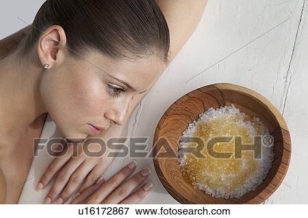 Stock Photo - Woman laying by bowl of sugar. Fotosearch