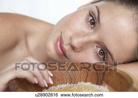 Stock Photograph - Woman laying by bowl of sugar. Fotosearch