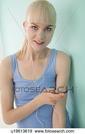 Stock Photo - Woman listening to headphones. Fotosearch