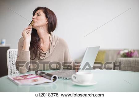 Woman paying her bills at home View Large Photo Image Stock Photograph - Woman paying her bills at home. Fotosearch