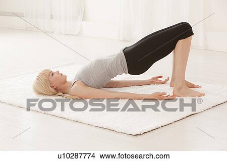 Woman practicing yoga View Large Photo Image Picture - Woman practicing yoga. Fotosearch