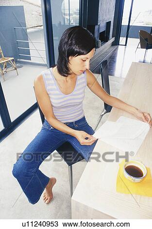 Woman reading in kitchen View Large Photo Image Stock Image - Woman reading in kitchen. Fotosearch