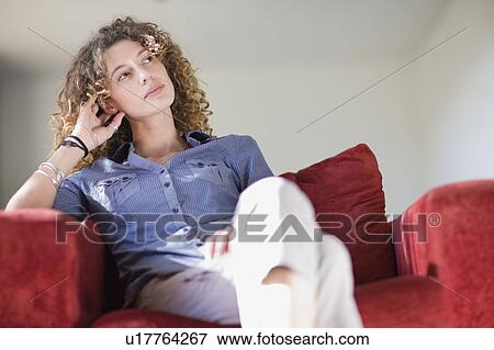 Woman relaxing in armchair View Large Photo Image Stock Photo - Woman relaxing in armchair. Fotosearch