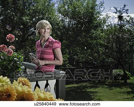 Woman relaxing on balcony View Large Photo Image Stock Photo - Woman relaxing on balcony. Fotosearch