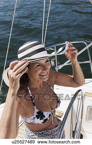 Woman relaxing on sailboat View Large Photo Image Stock Photo - Woman relaxing on sailboat. Fotosearch