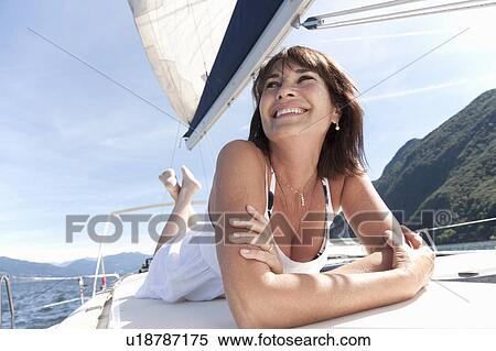 Woman relaxing on sailboat View Large Photo Image Stock Photography - Woman relaxing on sailboat. Fotosearch
