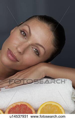 Stock Image - Woman resting her head on towel. Fotosearch