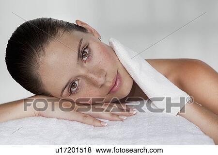 Woman scrubbing her face with cloth View Large Photo Image Stock Photo - Woman scrubbing her face with cloth. Fotosearch
