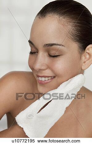 Woman scrubbing her face with cloth View Large Photo Image Stock Photography - Woman scrubbing her face with cloth. Fotosearch
