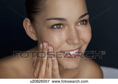 Woman scrubbing her face with sugar View Large Photo Image Stock Photo - Woman scrubbing her face with sugar. Fotosearch