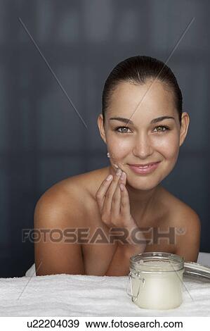 Woman scrubbing her face with sugar View Large Photo Image Stock Photo - Woman scrubbing her face with sugar. Fotosearch