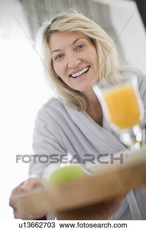 Woman serving breakfast in bed View Large Photo Image Stock Image - Woman serving breakfast in bed. Fotosearch