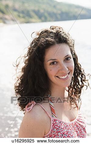 Stock Photography - Woman smiling by lake. Fotosearch