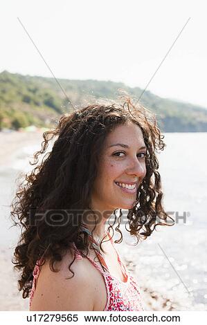 Stock Photography - Woman smiling by lake. Fotosearch