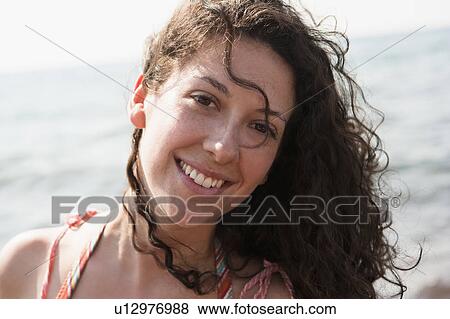 Woman smiling by water View Large Photo Image Stock Photo - Woman smiling by water. Fotosearch