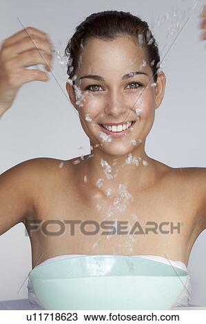 Stock Image - Woman splashing water. Fotosearch