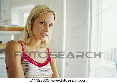 Woman standing in living room View Large Photo Image Stock Photography - Woman standing in living room. Fotosearch