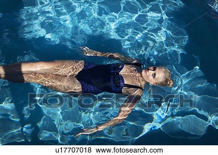 Stock Photo - Woman swimming in pool. Fotosearch