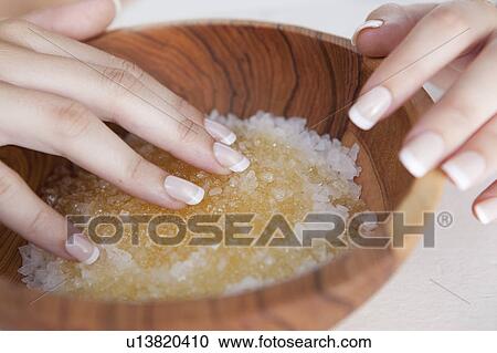 Stock Image - Woman touching bowl of sugar. Fotosearch