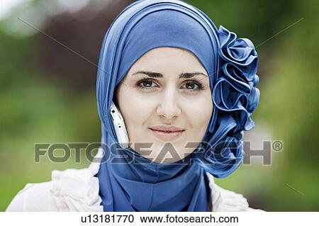 Woman with cell phone in headscarf View Large Photo Image Stock Image - Woman with cell phone in headscarf. Fotosearch